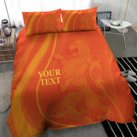 Orange bedding set with duvet and pillowcases, swirl pattern and 'YOUR TEXT'.