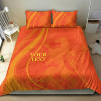 Orange duvet cover with matching pillowcases in swirl design and 'YOUR TEXT' print.