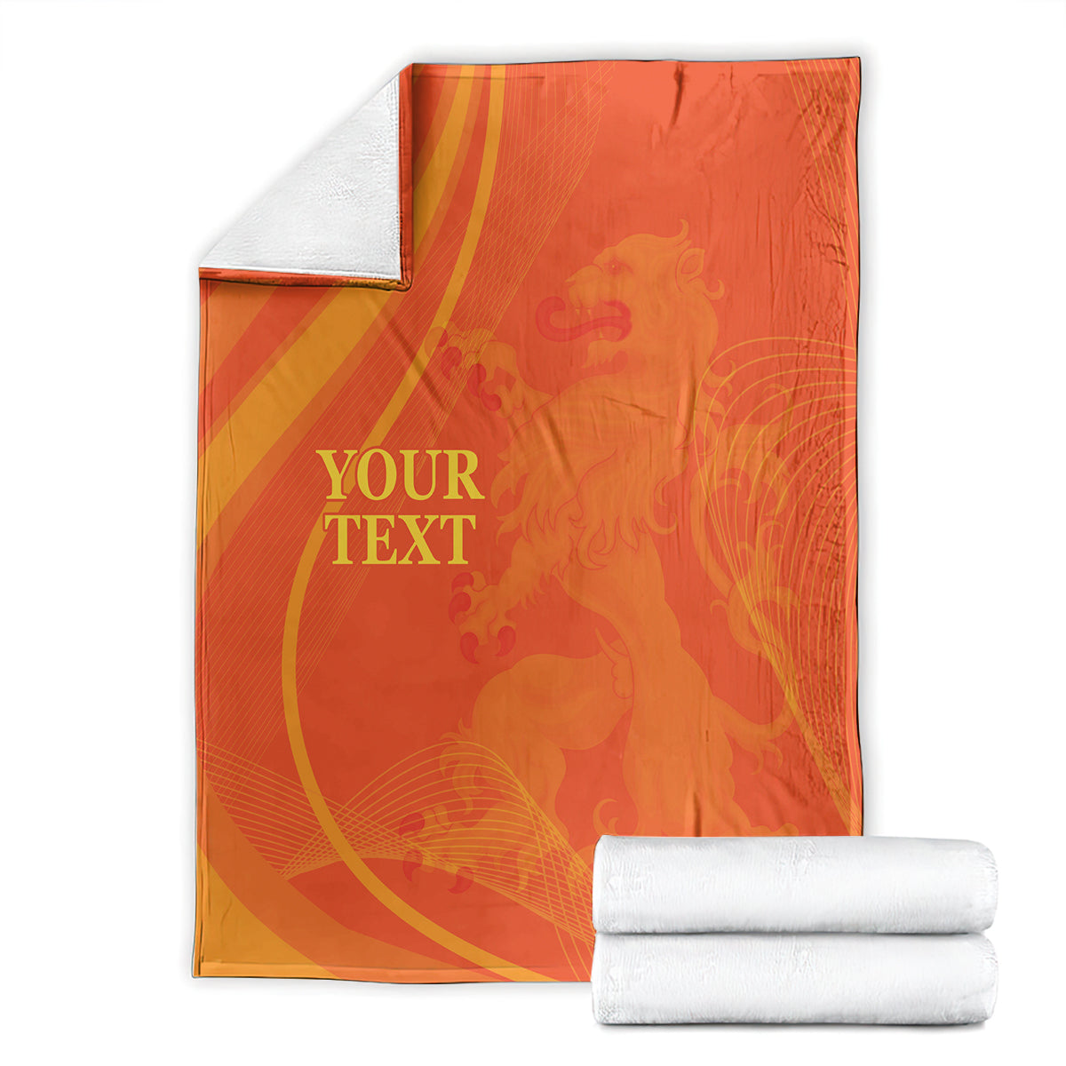 Orange blanket showing gold custom text and pattern, with neatly stacked white towels