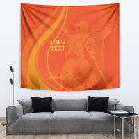 Orange rectangular tapestry with gold swirl artwork and centered placeholder text