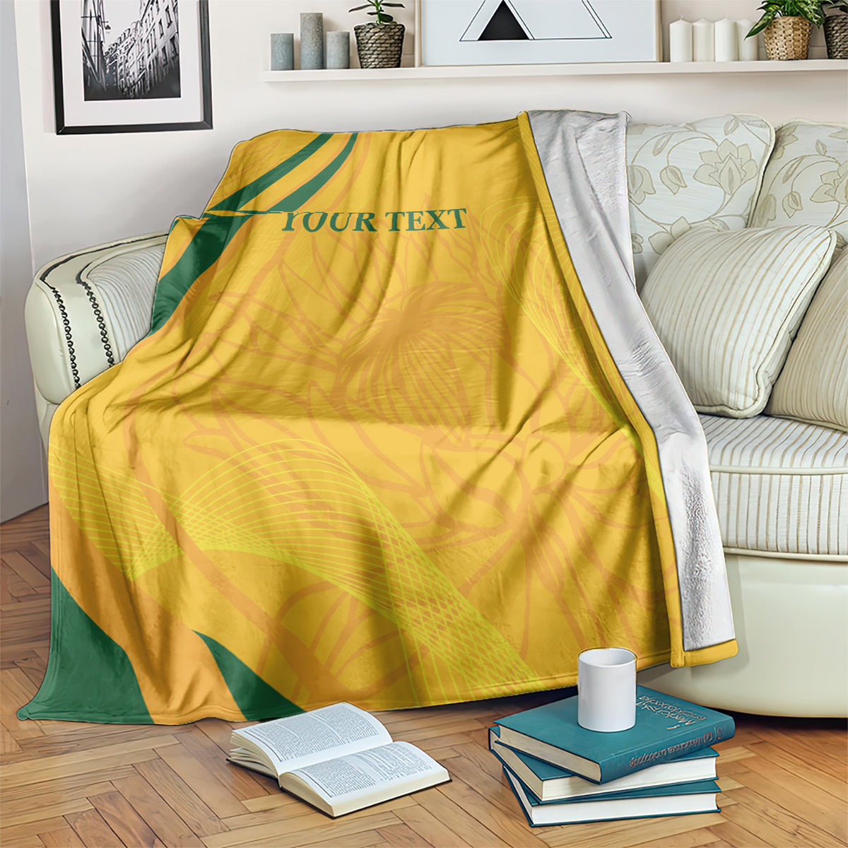 Gold cricket blanket with green diagonal stripe and printed text, covering an armchair