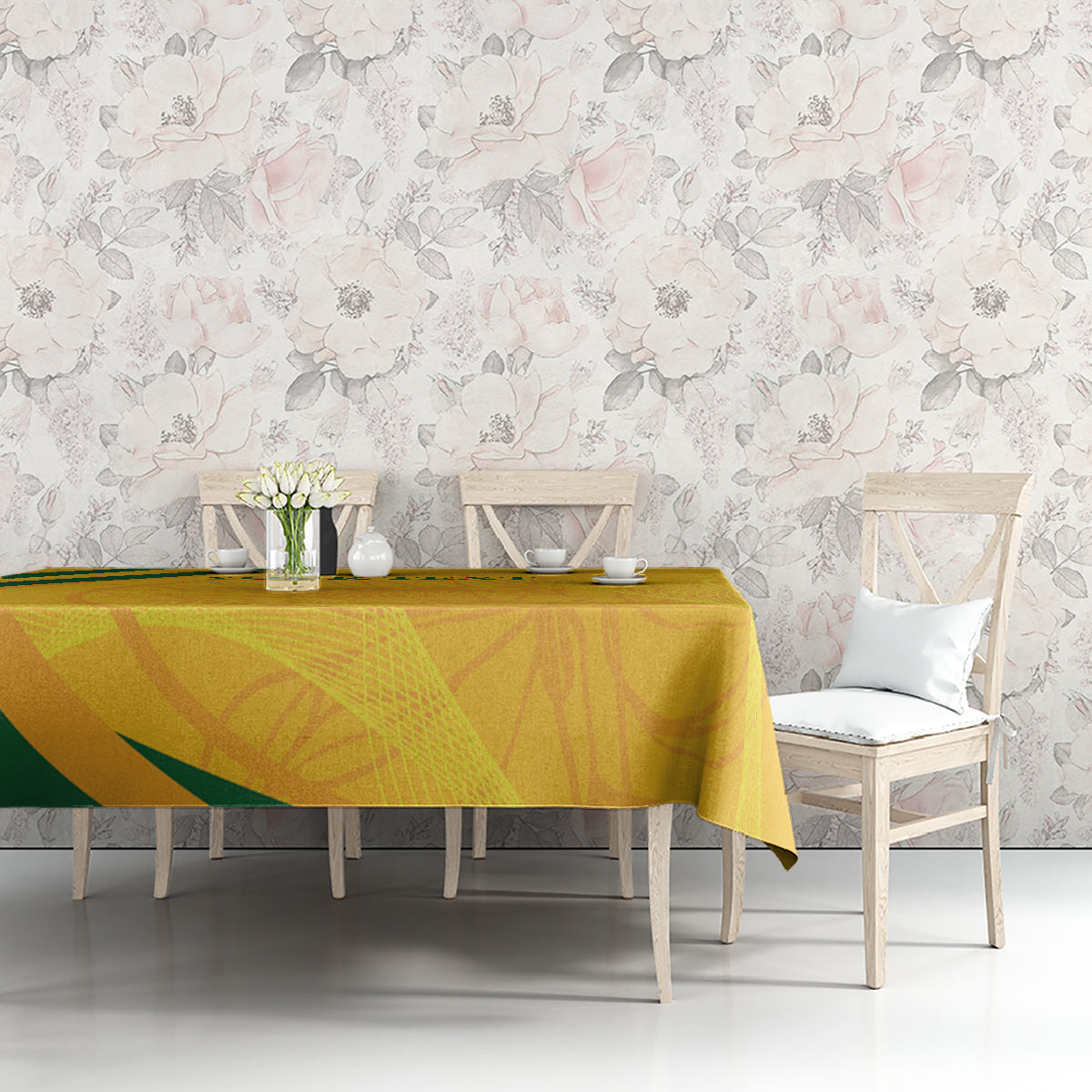 Gold and green patterned tablecloth over dining table with chairs and floral centerpiece