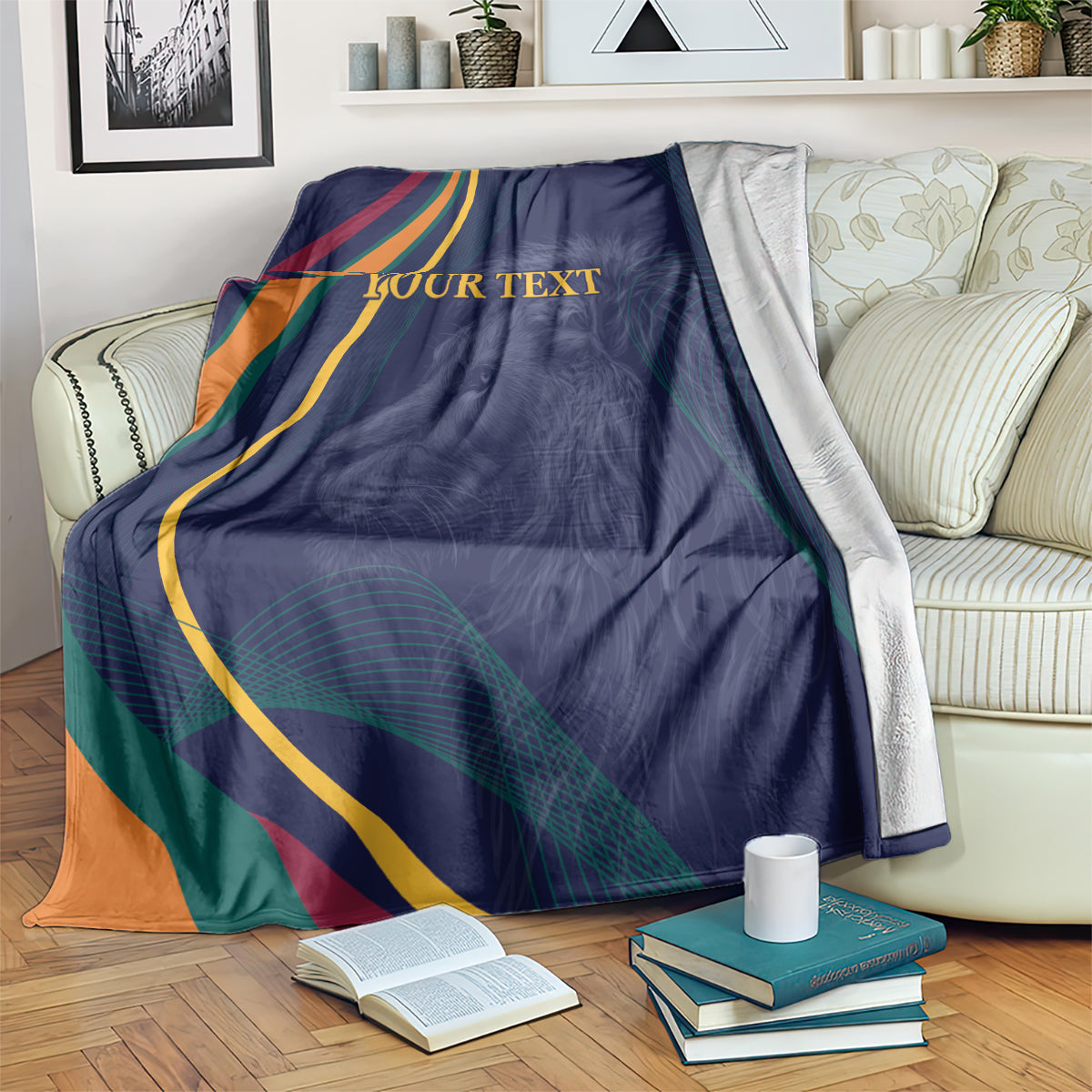 Blue blanket with multicolor ribbon stripes, lion graphic, and centered “YOUR TEXT” print