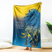 Lion print blanket in blue and yellow, draped with a large roaring lion design
