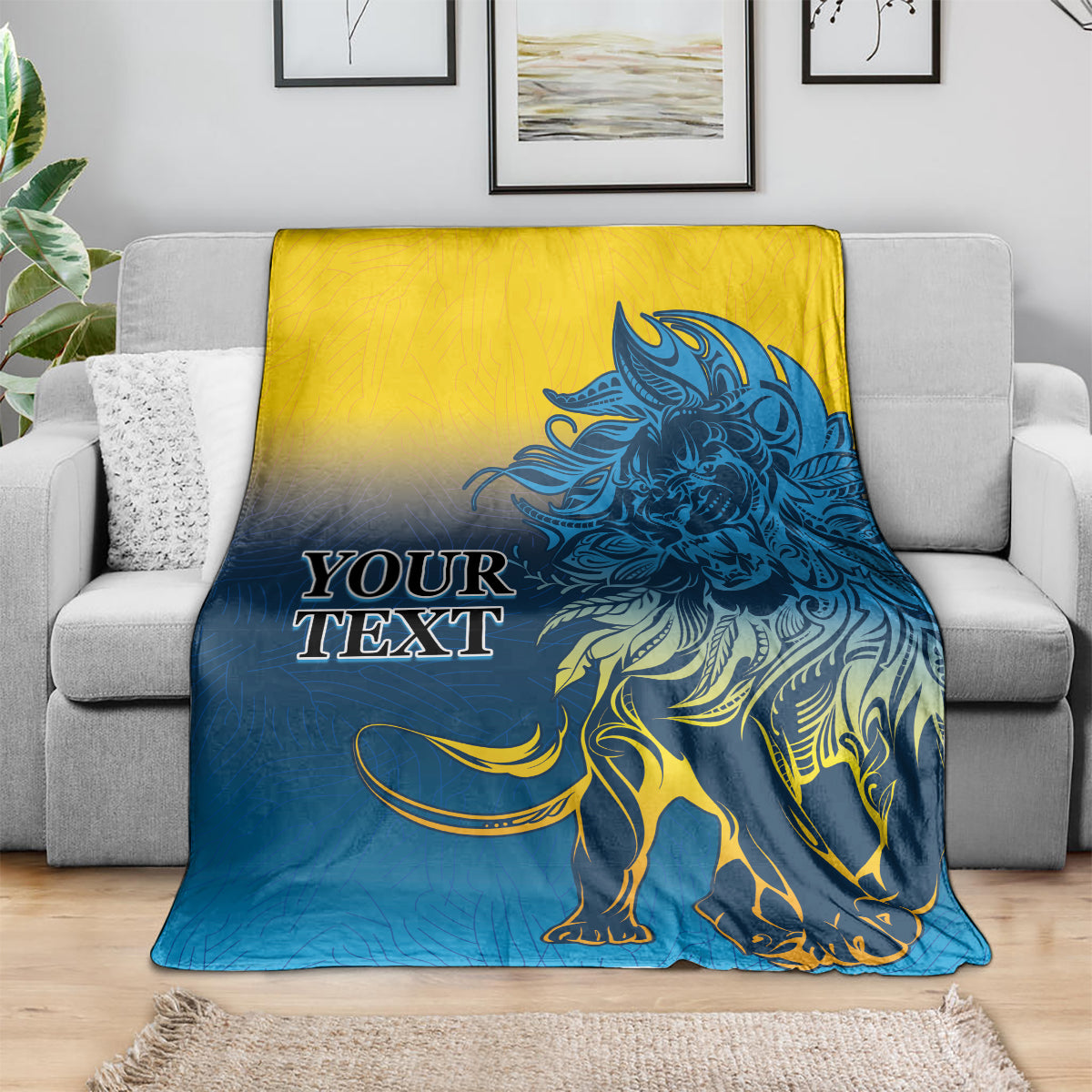 Lion print blanket in blue and yellow, spread over a couch with oversized lion graphic