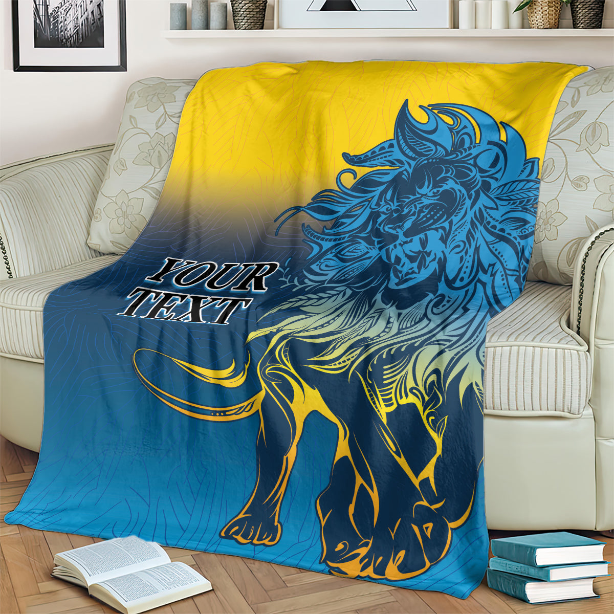 Lion print blanket in blue and yellow, spread on a sofa with lion face and mane detail