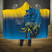 Hooded blanket with lion graphic, blue body and yellow hood, poncho-style front