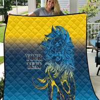 Quilt blanket with yellow top and blue bottom, diamond quilting, blue lion graphic, “YOUR TEXT”