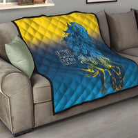 Folded quilt blanket on a couch with blue-and-yellow diamond quilting and blue lion, “YOUR TEXT”