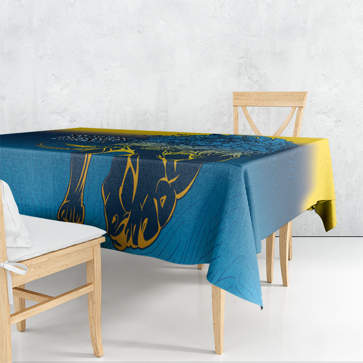 Blue lion-themed tablecloth with yellow motif, draped over dining table edge