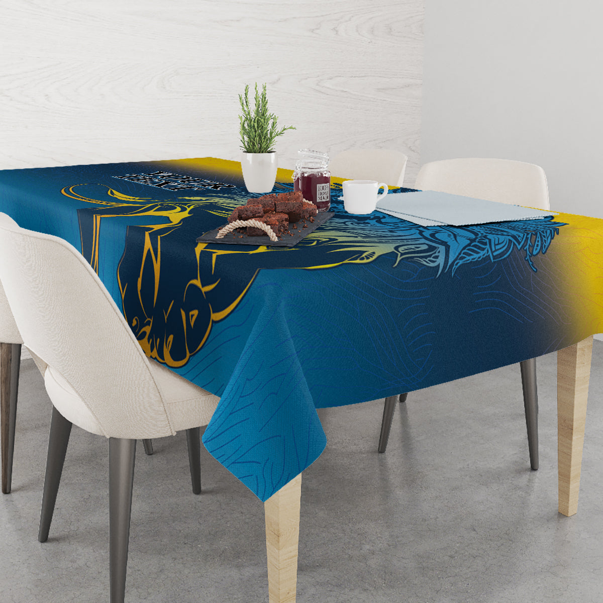 Blue tablecloth with lion print and yellow scroll details, set on dining table
