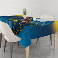 Blue tablecloth with lion print and yellow scroll details, set on dining table