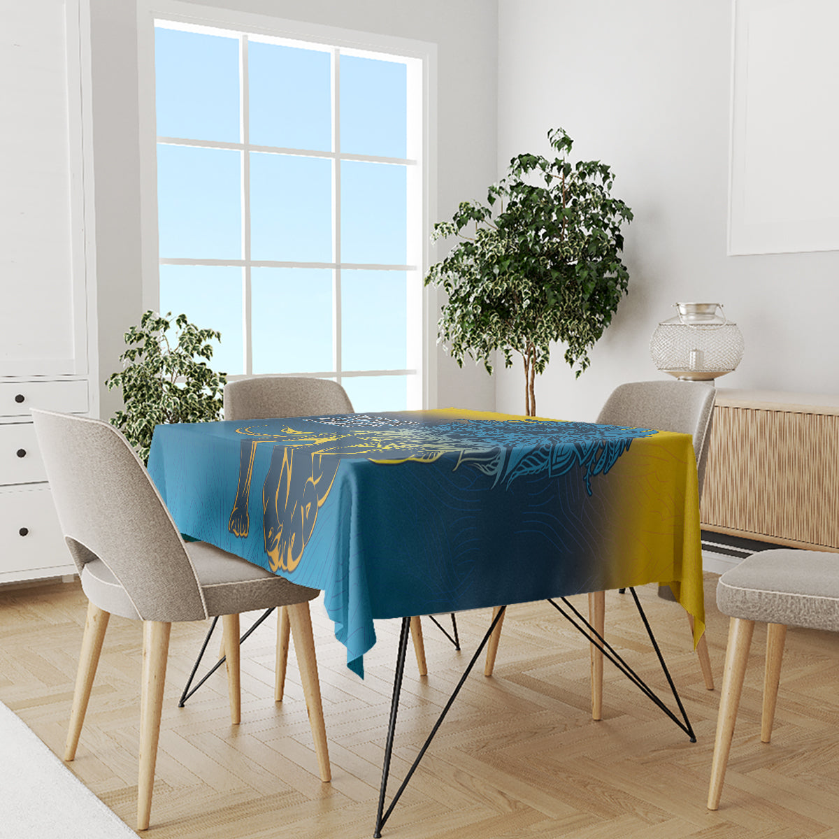 Blue tablecloth with lion print and yellow accents on dining table