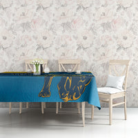 Blue tablecloth with lion motif and yellow decorative line, styled on dining table