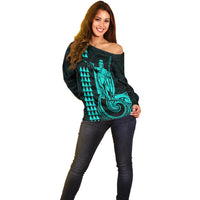 Off-shoulder sweater front with turquoise King Kamehameha and wave emblem, long sleeves