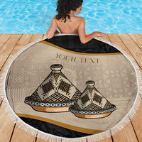 Round beach blanket with white fringe, beige tajine pattern and black band with gold stripe