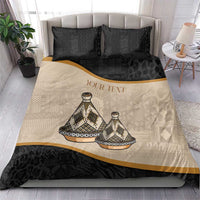 Bedding set on bed: black pillowcases and duvet with beige tribal print and gold border.