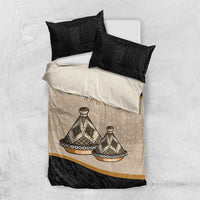 Bedding set flat lay: black and beige duvet cover with tribal print and two black pillowcases.