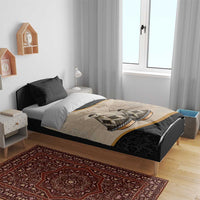 Bedding set on bed: beige-and-black duvet with tribal artwork and gold stripe, two pillows.