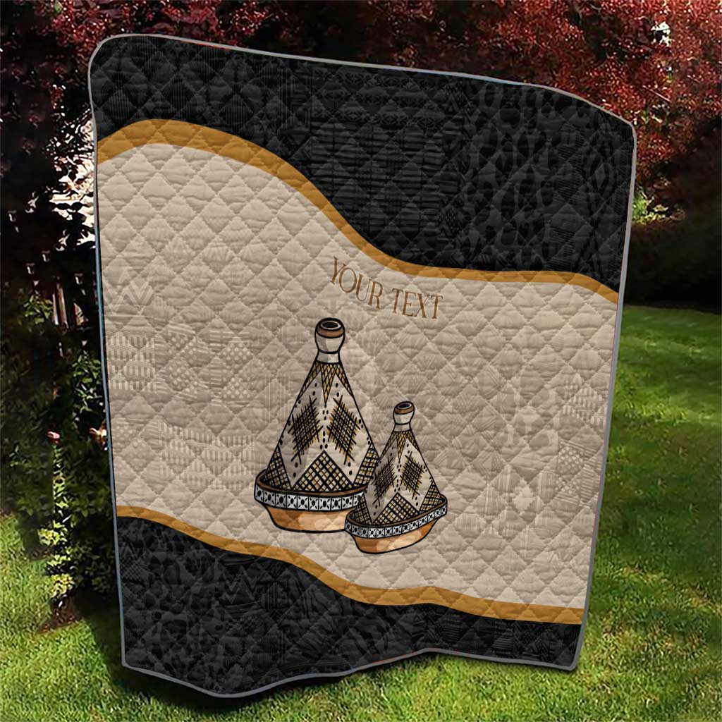 Black and beige quilt with conical tribal figures, gold diagonal stripe, diamond-stitch texture