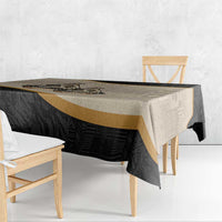 Black, beige, and gold striped tablecloth with tribal motifs and border trim