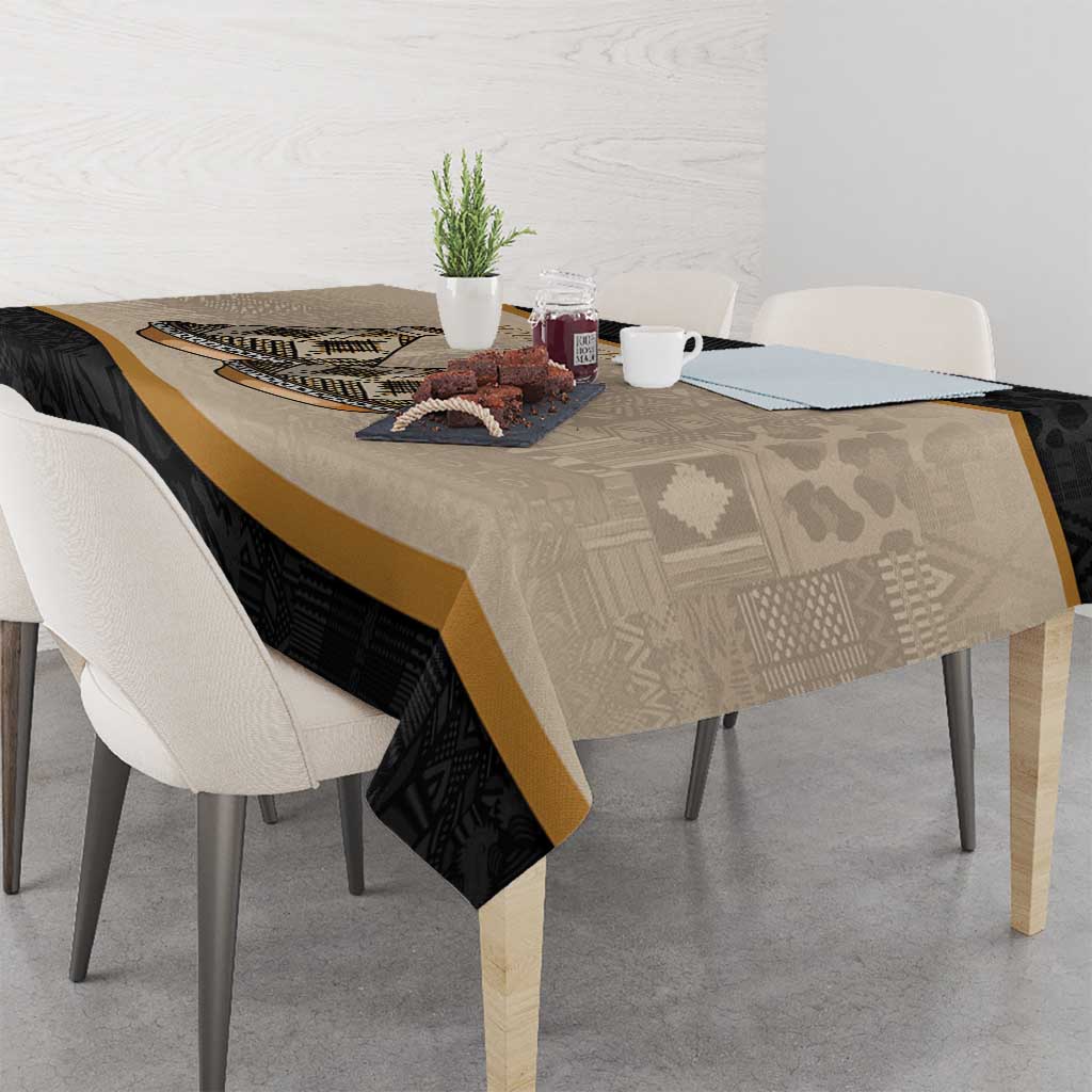 Beige and black tablecloth with Moroccan tribal pattern, gold stripe, and tajine motif