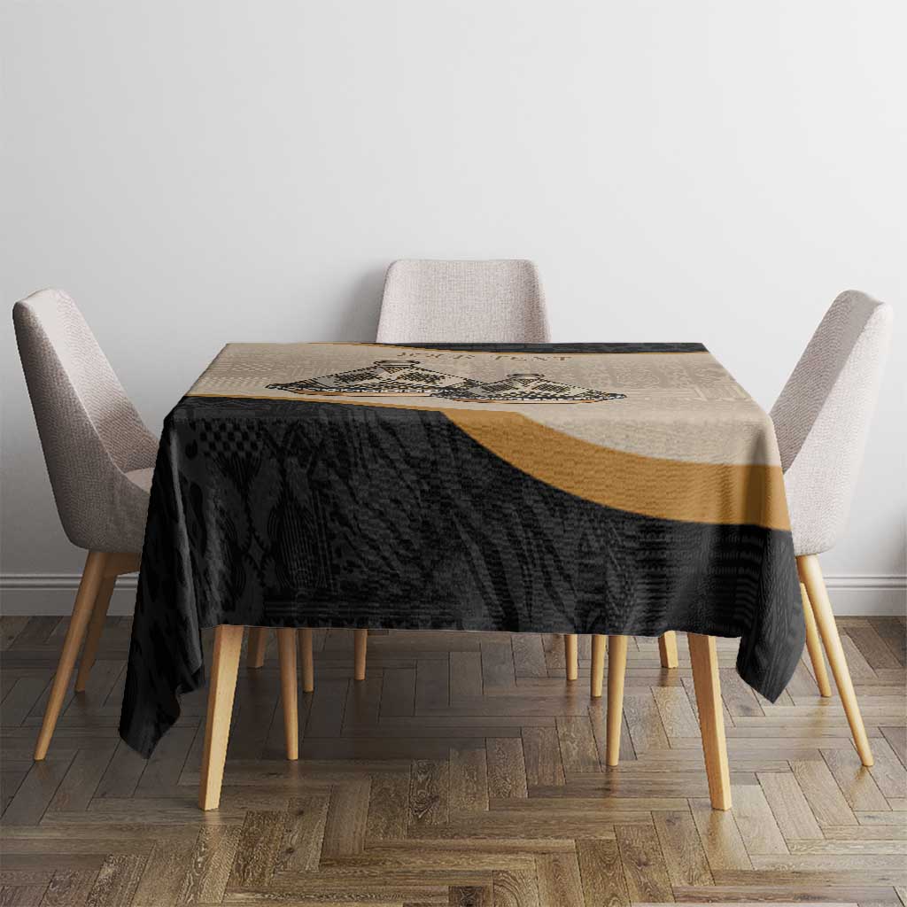 Black and beige tablecloth with gold band and intricate geometric tribal design