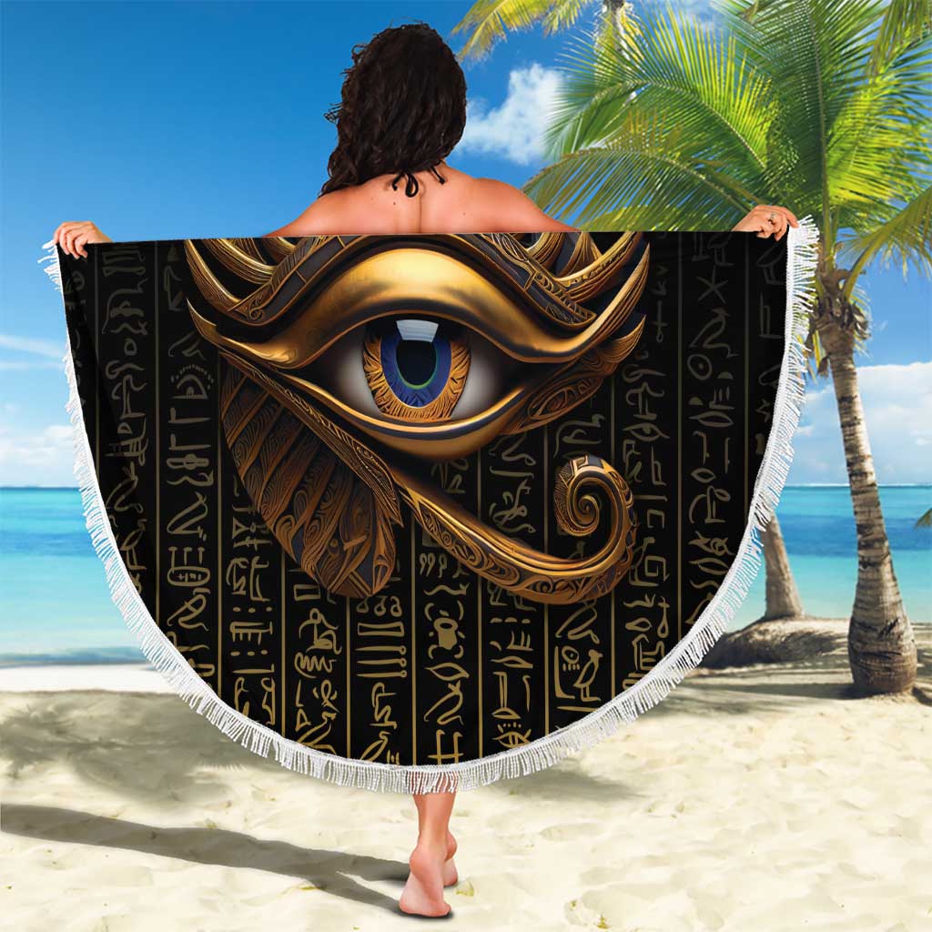 Round black Eye of Horus beach blanket with gold design and Egyptian hieroglyphs, fringed trim