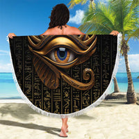 Round black Eye of Horus beach blanket with gold design and Egyptian hieroglyphs, fringed trim
