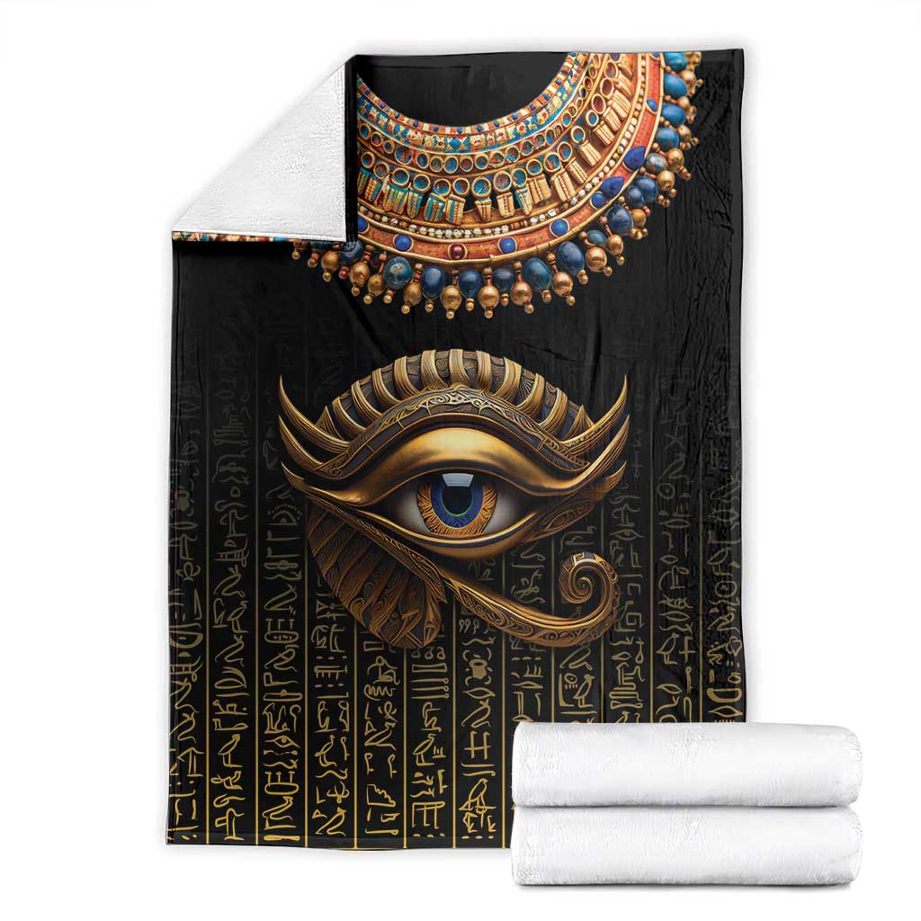 Black blanket with Eye of Horus artwork and gold hieroglyph print, folded