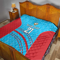 Blue and red cricket quilt laid on a bed, featuring 'YOUR TEXT 21' and ball emblem.
