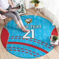 Round blue cricket carpet laid flat with red side shapes, cricket emblem, 'Your text 21'