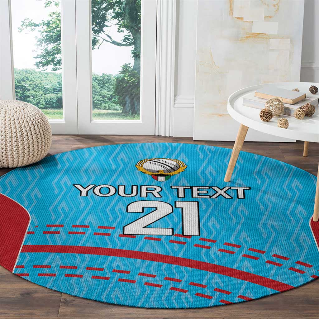 Round blue cricket carpet with red side panels, 'Your text 21' text, and cricket emblem