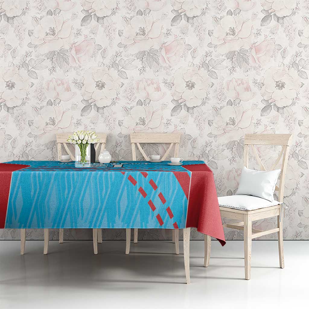Cricket tablecloth with blue textured pattern, red edge, and drape on dining set