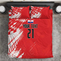 Red bedding set with white sporty graphic pattern, custom text, and number 21 on duvet and pillows