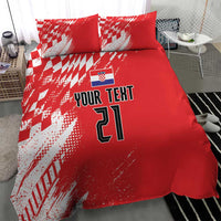 Red bedding set featuring white sporty pattern, custom text, and number 21 on the duvet