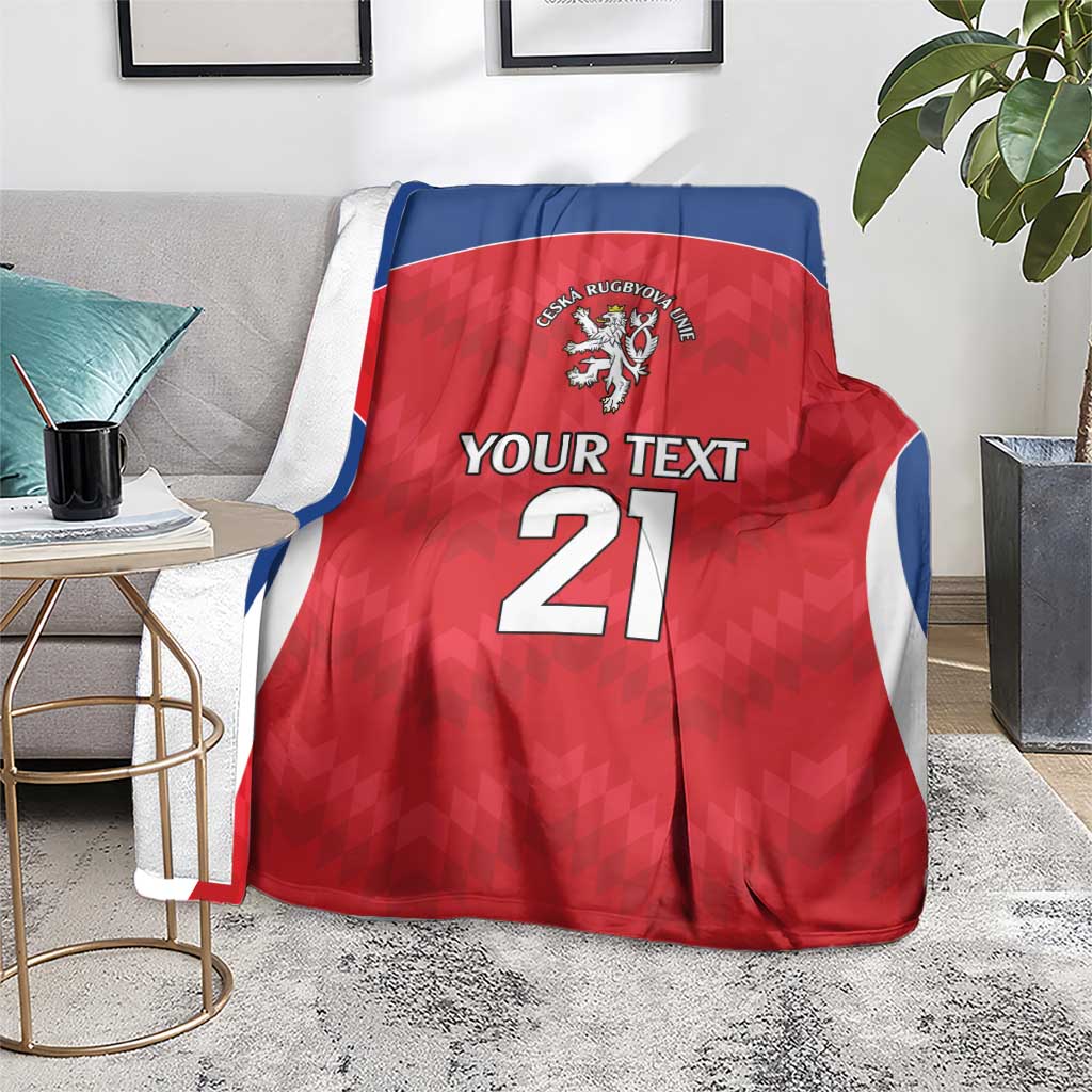 Red rugby blanket with blue trim, crest logo, 'Your Text' and number 21, draped