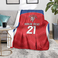 Red rugby blanket with blue trim, crest logo, 'Your Text' and number 21, draped