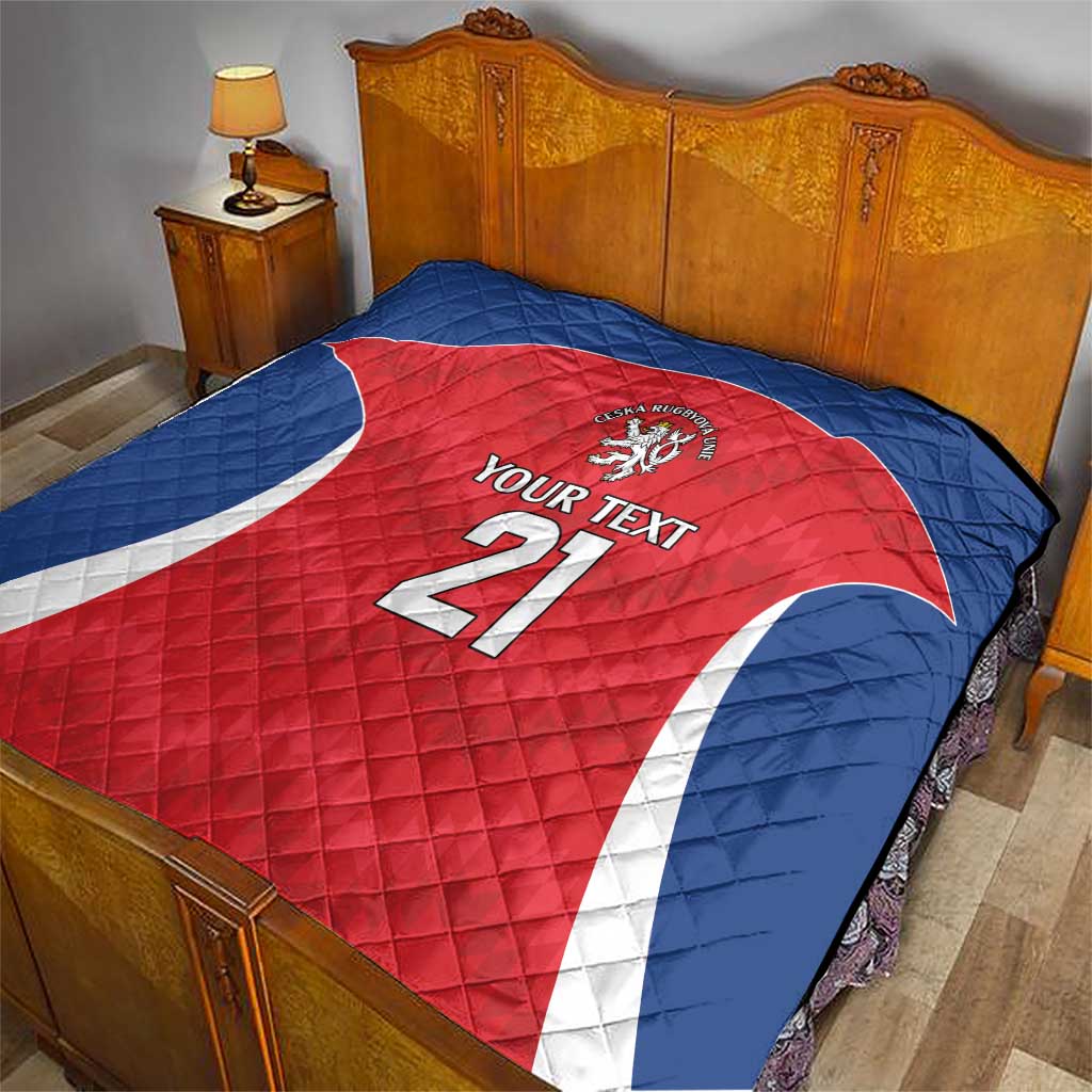 Rugby custom quilt on a bed: blue backing with red jersey panel, “YOUR TEXT” 21, lion crest
