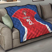 Rugby quilt on a sofa with blue backing and red jersey, lion crest, “YOUR TEXT” 21