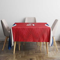 Red rugby tablecloth with lion crest, blue-and-white accents, and hemmed drop edges
