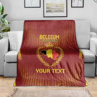 Red Belgium football blanket draped on a sofa, gold crest and 'YOUR TEXT' print