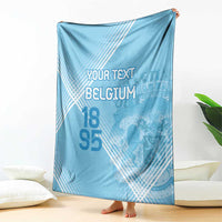 Light blue football blanket draped with custom text, Belgium graphic, and 95 numerals