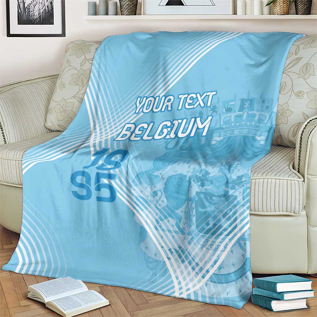 Light blue football blanket on sofa with custom text, Belgium logo, and 95 numerals