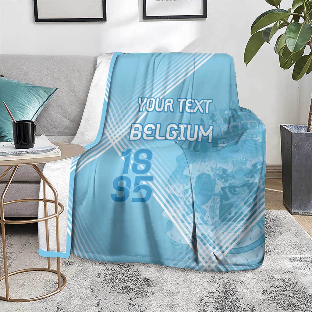 Light blue football blanket on floor with custom text, Belgium graphic, and 95 numerals