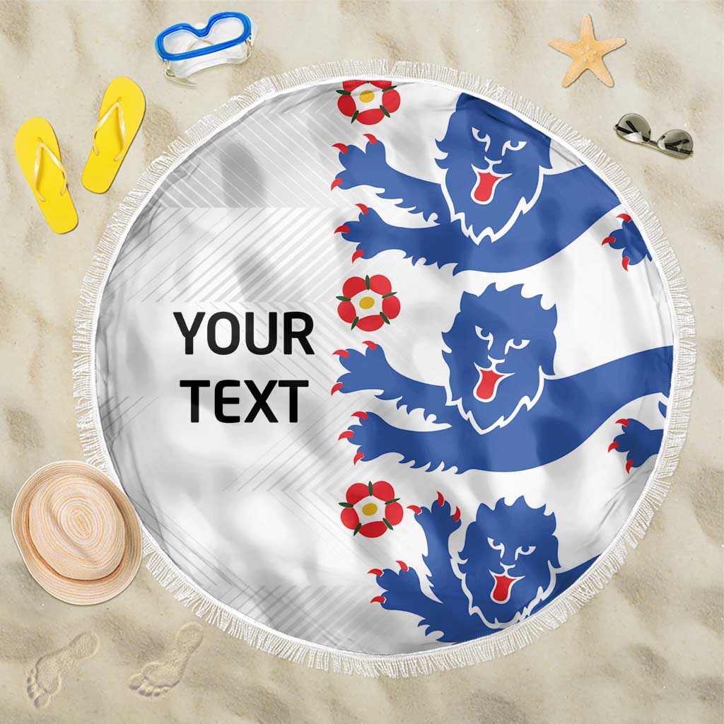 Round white beach blanket with blue Triple Lions pattern, red roses, and fringed edge.