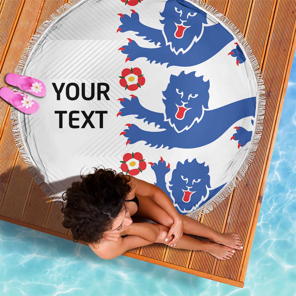 Round white beach blanket with blue lions and 'YOUR TEXT' print, fringed edge.