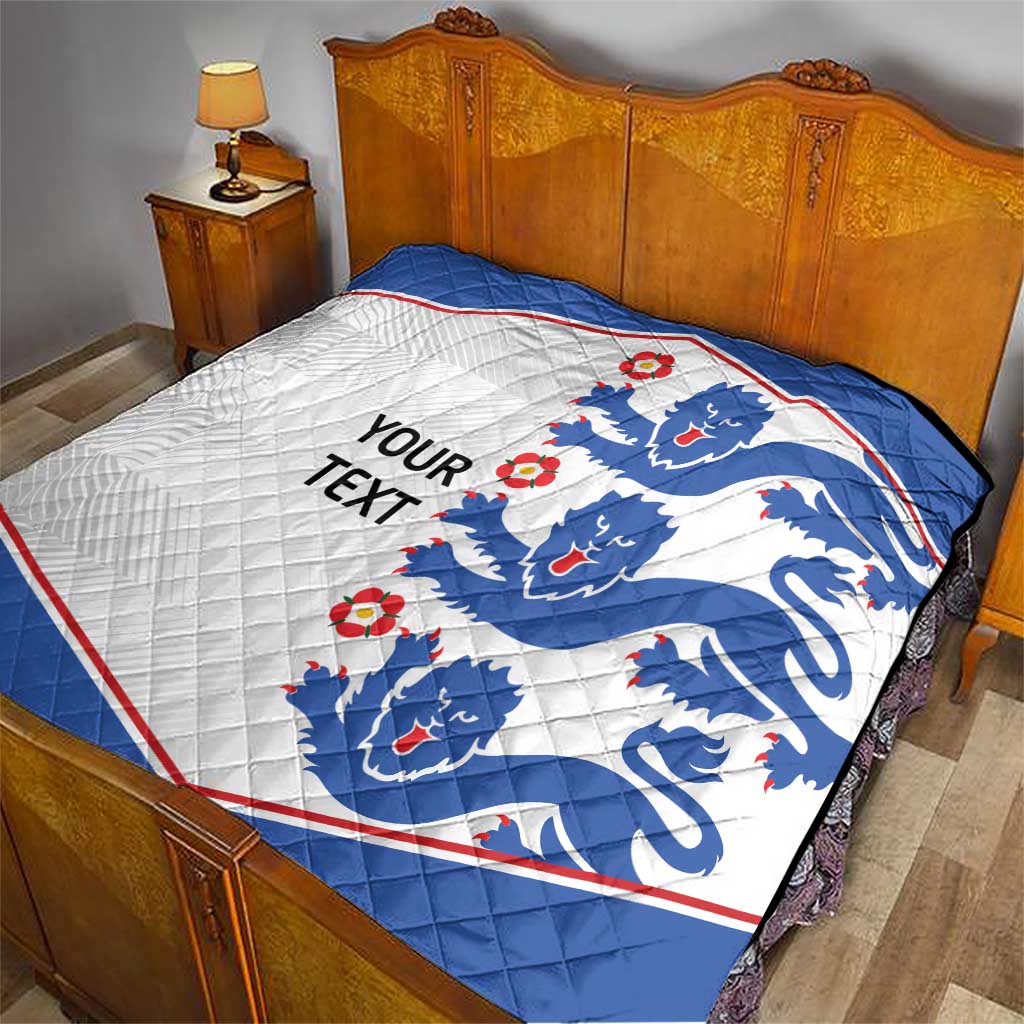 Blue and white quilt blanket with lion crests and red border on bed