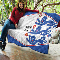 Blue and white quilt blanket with lion emblems and red trim, 'YOUR TEXT' text