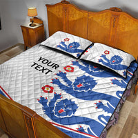 White and blue England quilt bed set with lion crests, red flower accents, and 'YOUR TEXT' on quilt